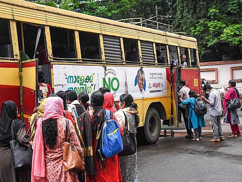 Kerala High Court employees board a bus, arranged for them, as offices open during the fourth phase of COVID-19 lockdown, in Kochi, Monday, May 18, 2020.