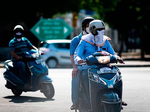Motorists ride along a street during a government-imposed nationwide lockdown to prevent the spread of COVID-19 in New Delhi on May 5, 2020.