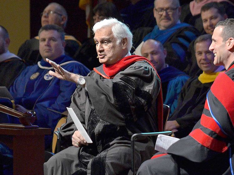 In this March 30, 2016 file photo, Christian apologist and author Ravi Zacharias, left, talks with associate professor Lenny Luchetti during the Society of World Changers induction ceremony at Indiana Wesleyan University in Marion, Indiana. Zacharias died Tuesday, May 19, 2020 at his home in Atlanta after a brief battle with sarcoma, Ravi Zacharias International Ministries said in a statement.