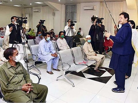 Prime Minister Imran Khan interacting with the beneficiaries at the launching of the cash assistance programme for jobless in Islamabad.