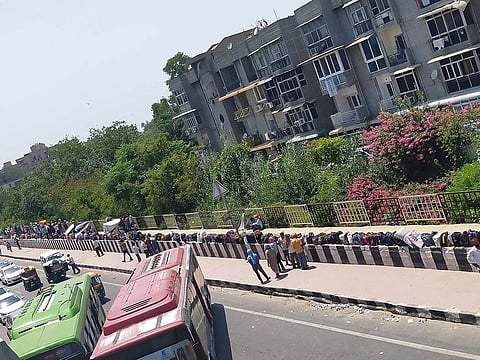 Migrant workers' bags line India's roads as they wait to go home