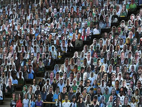 Business disruptions and event cancellations have had insurers bleed losses during the first-half of 2020. In this file picture, cutouts replace actual fans at a football match in Germany.