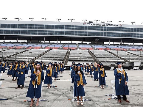 Little Elm High School graduates stand six feet apart from each other during graduation ceremonies at Texas Motor Speedway on May 21, 2020 in Fort Worth, Texas.