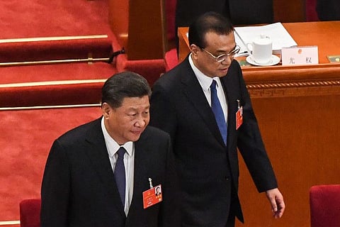 Chinese President Xi Jinping (L) and Premier Li Keqiang (R) arrive for the opening session of the National People's Congress (NPC) at the Great Hall of the People in Beijing on May 22, 2020. China faces "immense" economic challenges as it emerges from the coronavirus pandemic, Premier Li Keqiang warned on May 22 as he opened his nation's annual legislative session that will seek to tighten Beijing's control over Hong Kong.