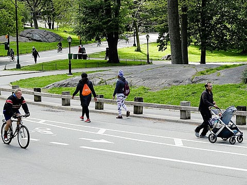 Bicyclists and runners enjoy Central Park, Saturday, May 9, 2020, in New York during the coronavirus pandemic
