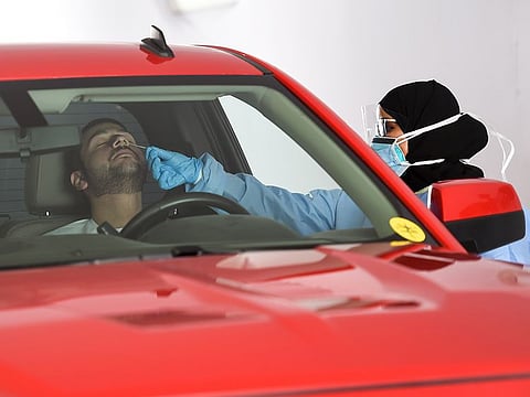 Paramedics taking swab sample at the SEHA drive through National Screening Center located at Golf and Shooting Club in Sharjah.