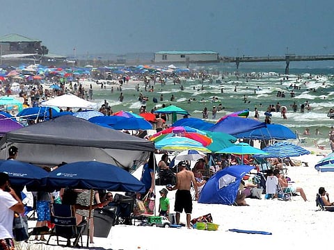 People pack the beaches on Okaloosa Island, Florida on May 23, 2020, as the long Memorial Day weekend began. Vacationers from Texas, Georgia, Alabama, and Arkansas have crowded the reopened beaches after the lifting of many state's stay-at-home restrictions due to the coronavirus pandemic.