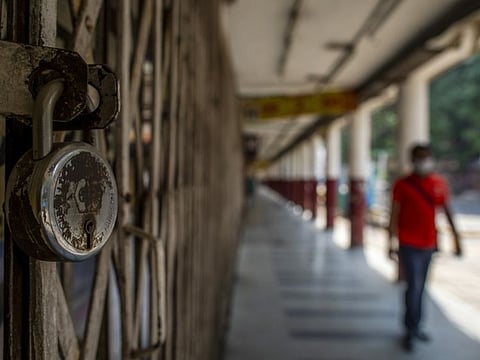 A padlock hangs from a shuttered store in a near-empty Connaught Place during a partial lockdown imposed due to the coronavirus in New Delhi, India, on Thursday, May 14, 2020. India spelled out the details of its massive rescue package that will initially help small businesses and utility companies as Prime Minister Narendra Modi gears to restart the economy cratered by the coronavirus pandemic. Photographer: Prashanth Vishwanathan/Bloomberg