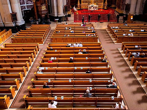 In this file photo taken on May 10, 2020 members of the congregation wearing protective face masks observe social distancing as they attend a Sunday service at the Berliner Dom cathedral in Berlin, amid the Covid-19 coronavirus pandemic. When the Berlin Cathedral Choir gathered for a rehearsal on March 9, 2020, the new coronavirus was still a distant concern, with under 50 confirmed cases in the German capital. But five days later, one of the ensemble's 80 singers contacted choir director Tobias Brommann to say she had tested positive for COVID-19.