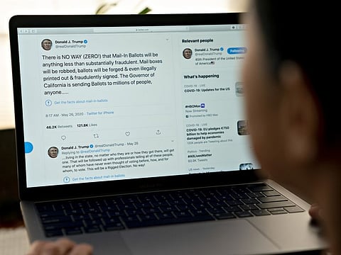 Fact-checked labels are applied to tweets by US President Donald Trump on laptop computer in an arranged photograph taken in Arlington, Virginia, US, on Wednesday, May 26, 2020.
