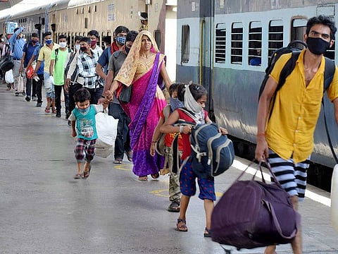 Migrants arrive to board a Shramik special trains to travel to their homes during the ongoing COVID-19 lockdown, at Prayagraj Railway Station, Thursday, May 28, 2020.