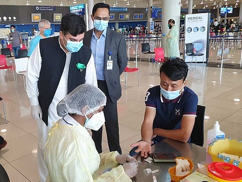 Pakistan Consul General in Dubai Ahmed Amjad Ali (left) says all passengers are tested for COVID-19 at the airport before boarding the plane.