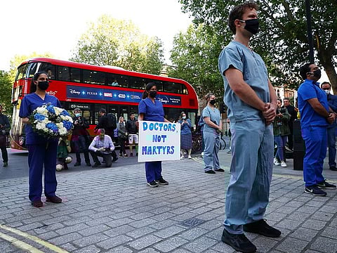 Medical staff protest at the gates of Downing Street after the last day of the Clap for our Carers campaign in support of the NHS, following the outbreak of the coronavirus disease (COVID-19), in London, Britain, May 28, 2020.