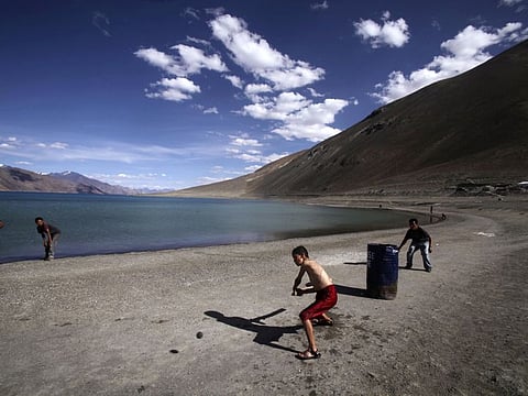 In this Friday, July 22, 2011 photo, children play cricket near Pangong Lake, near the India-China border in Ladakh, India.