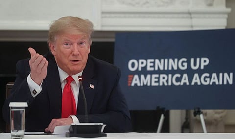 US President Donald Trump speaks during a roundtable discussion with industry executives on reopening businesses during the COVID-19 pandemic in the State Dining Room at the White House in Washington, on Friday.