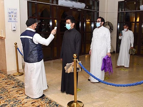 Worshippers have their temperatures checked Sunday before allowed into a Jeddah mosque