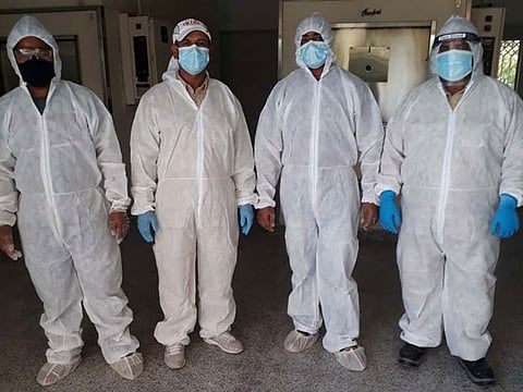 Crematorium workers in Dubai in full PPE