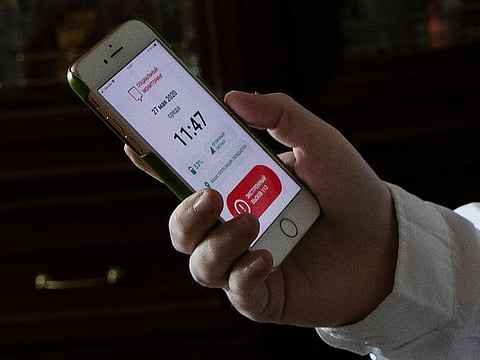 Vladimir Perevalov shows a Social Monitoring app installed on his smartphone in his apartment in Shcherbinka, outside Moscow, Russia.