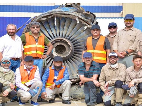 French and Pakistan investigation team members after completing investigation on the PIA plane crash site in Karachi.