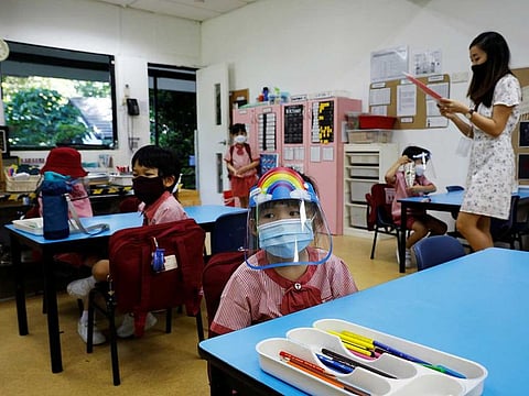 Children wearing protective face masks and shields attend preschool classes in Singapore. Singaporeans will have to prepare for a different, admittedly tougher future with rising unemployment as companies said Prime Minister Lee Hsien Loong.