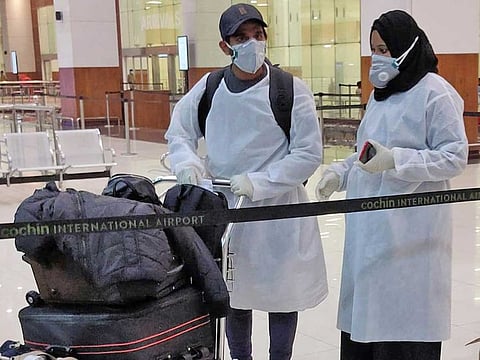 Passengers leave Cochin International Airport in Kerala after arriving on an Air India Express special flight from Dubai on Friday.