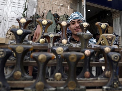 A vendor selling traditional daggers, or Jambiyas, waits for customers as he poses for the camera at his market stall amid novel coronavirus spread concerns in the old quarter of Sana'a on June 2.