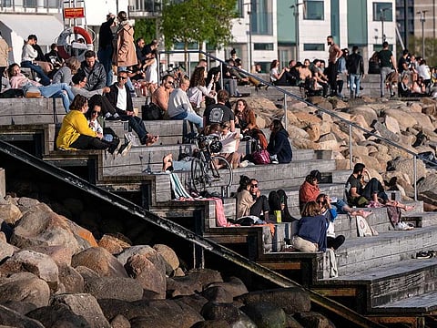 People enjoy the warm evening weather in Malmo, Sweden, Tuesday May 26, 2020. Sweden has defended its response to the COVID-19 global pandemic despite the country now reporting one of the highest mortality rates in the world with 4,125 fatalities, about 40 deaths per 100,000 people.