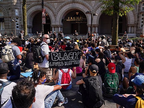 Demonstrators gather to protest the death of George Floyd, Wednesday, June 3, 2020, outside of the Trump International Hotel on Pennsylvania Avenue in Washington.