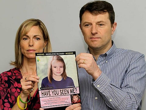 In this May 2, 2012 file photo, Kate and Gerry McCann pose for the media with a missing poster depicting an age progression computer generated image of their daughter Madeleine at nine years of age, to mark her birthday and the 5th anniversary of her disappearance during a family vacation in southern Portugal in May 2007, during a news conference in London.