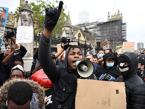 British actor John Boyega speaks to protestors in Parliament square during an anti-racism demonstration in London.
