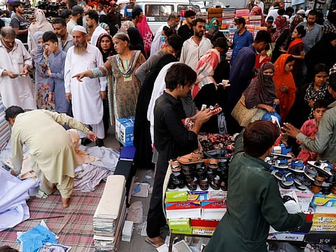 File picture of people shopping from stalls ahead of the Eid Al Fitr celebrations after the government eased coronavirus lockdown restrictions, in Karachi, Pakistan May 21, 2020.