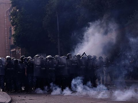Lebanese riot policemen clash with anti-government protesters during ongoing protests against the Lebanese government, in downtown Beirut, Lebanon, Saturday, June 6, 2020