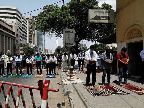 People attend Friday prayers along a road at a business area, after Pakistan eased lockdown restrictions, as the outbreak of the coronavirus disease (COVID-19) continues, in Karachi, Pakistan June 5, 2020.