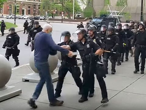 A Buffalo police officer appears to shove a man who walked up to police Thursday, June 4, 2020, in Buffalo, N.Y.