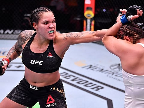 Amanda Nunes punches Felicia Spencer during their UFC featherweight championship bout