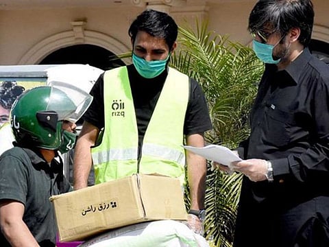 Britain's Queen Elizabeth honours two Pakistani volunteers Huzaifa Ahmad and Syed Hassaan Irfan, who feed the poor across the country.
