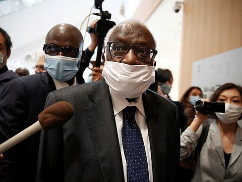 Lamine Diack, former President of the International Association of Athletics Federations (IAAF), wearing a face mask, arrives for his trial at the Paris courthouse on Monday.