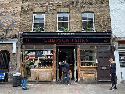 People observe social distancing rules outside Climpson & Sons coffee shop in Hackney, following the outbreak of the coronavirus disease (COVID-19), London, Britain