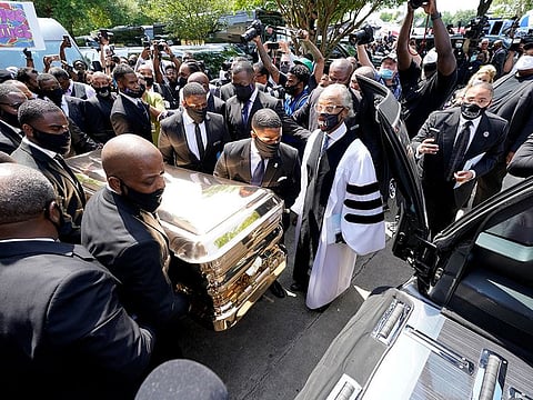 The casket of George Floyd is pushed into the hearse as the Rev. Al Sharpton (right) looks on after the funeral service at the Fountain of Praise church, in Houston, Texas, U.S., June 9, 2020.