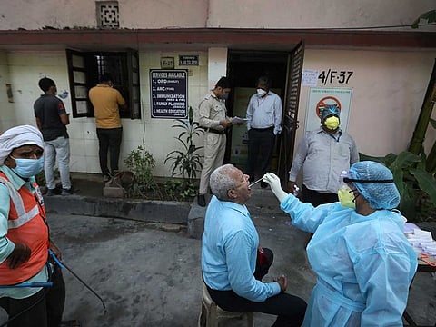 A health worker takes a swab test of an elderly man for COVID-19 in New Delhi, India, Wednesday, June 10, 2020. With thousands of cases reported daily now India stands the fifth highest in the world of coronavirus cases.