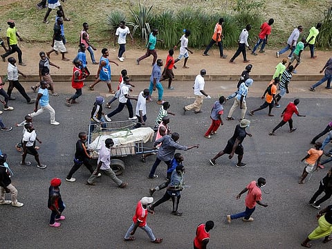 Residents protest with the body of a man they said was beaten by police for being outside during a curfew in the Mathare slum in Nairobi, Kenya