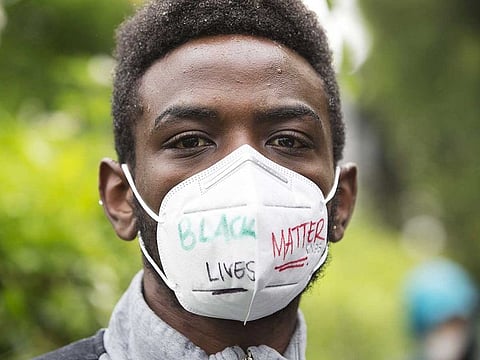 William Ngugi walks with others during a Black Lives Matter of Seattle-King County silent march on June 12, 2020 in Seattle, Washington, US.