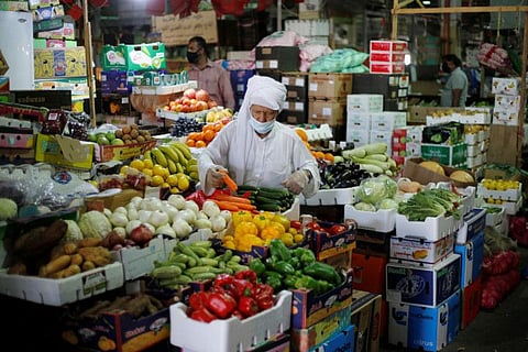 A Bahraini man, wearing a face mask, following the outbreak of COVID-19, shops at a vegetables stand, in Central Market, in Manama, Bahrain, June 13, 2020.