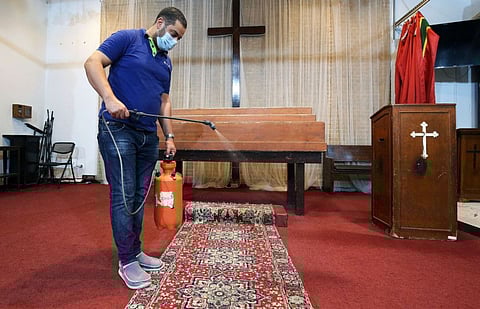 A worker sterilises the National Evangelical Church in Kuwait City on June 11.