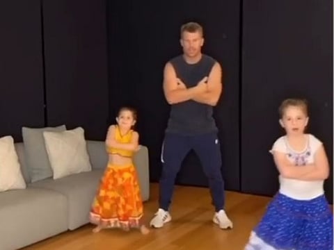 David Warner with his two daughters.