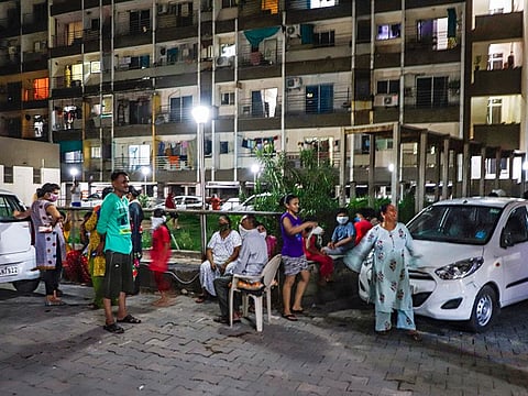 People move out of their apartments and compounds to an open area following an earthquake, in Ahmedabad, on June 14, 2020.