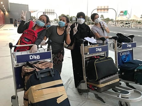 DON'T WORRY, BE HAPPY: Some of the 370 Filipinos recently repatriated from the UAE pose for a group shot prior to their Dubai-Manila flight. Upon arrival, all returnees are then taken to a government-designated quarantine centre in Manila.
