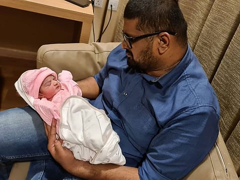 Khaleel Kadermon, 30 years old, an Indian from Kerala was stuck in Abu Dhabi when his wife had labour pain. His wife delivered the baby two days later after he reached Sharjah from Abu Dhabi during travel restriction. He hold his daughter, Khairah, who born on June 14. Supplied by the father.