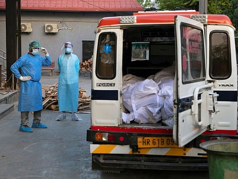 Mohammad Aamir Khan, an ambulance driver, waits for the relatives to unload the bodies of people who died due to the coronavirus disease (COVID-19) for their cremation at a crematorium in New Delhi, India, June 11, 2020.