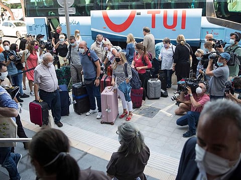 German tourists arrive at the RIU Concordia hotel in Palma de Mallorca on June 15, 2020, as part of a pilot programme to reactivate tourism a week before Spain reopens its borders. Spain, one of the world's leading tourist destinations, will next June 21 re-establish free travel with fellow EU countries.